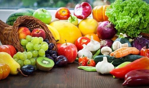A worker in a warm jacket inspecting goods in a cold storage facility.
